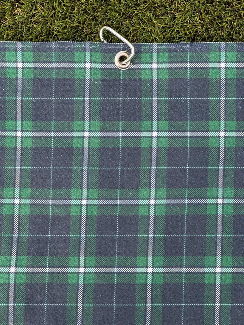 Microfiber golf towel in dark green and blue plaid pattern, hanging with metal carabiner