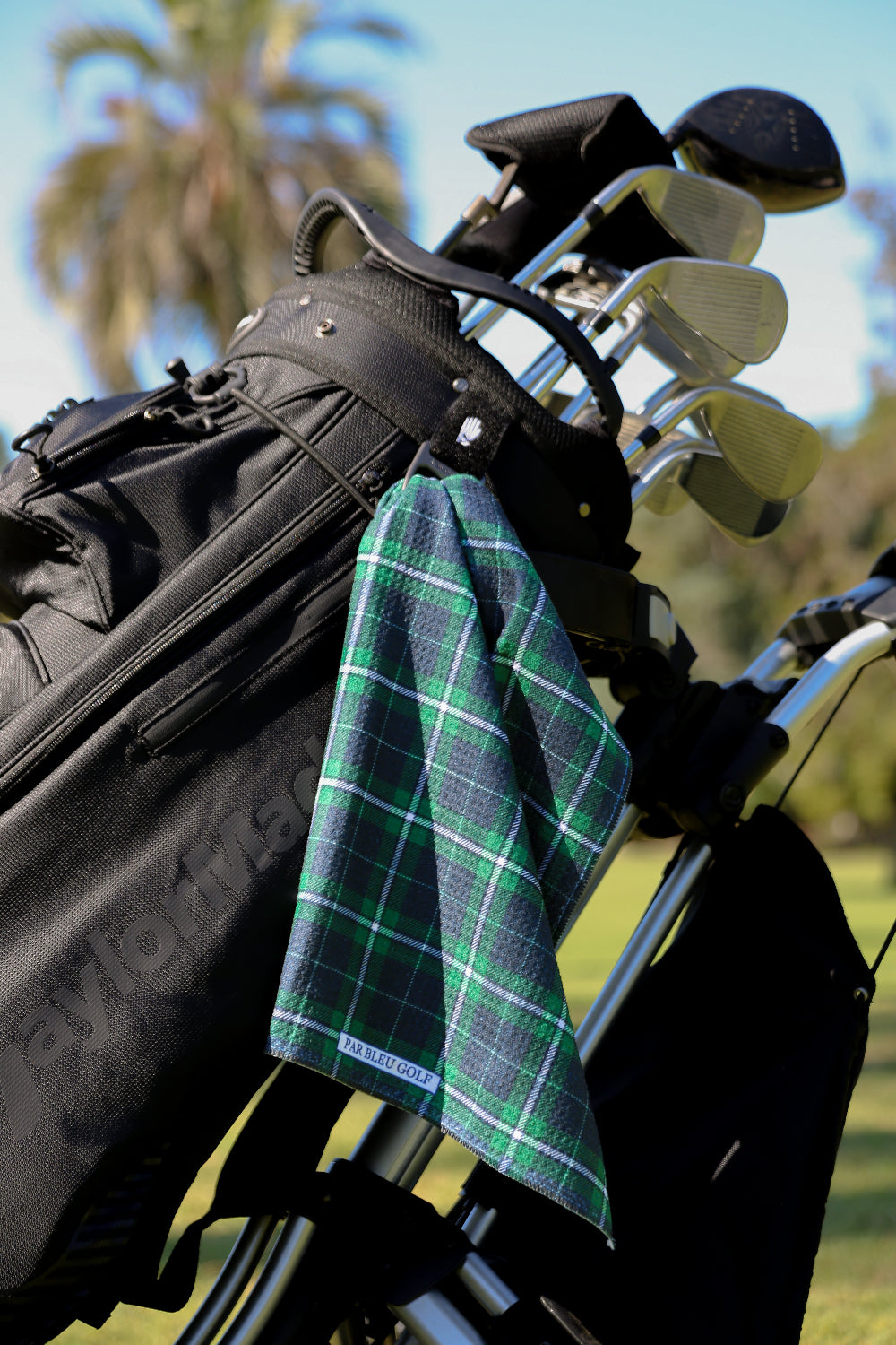 Par Bleu’s green and blue plaid towel clipped to a golf bag, durable and lightweight for every round