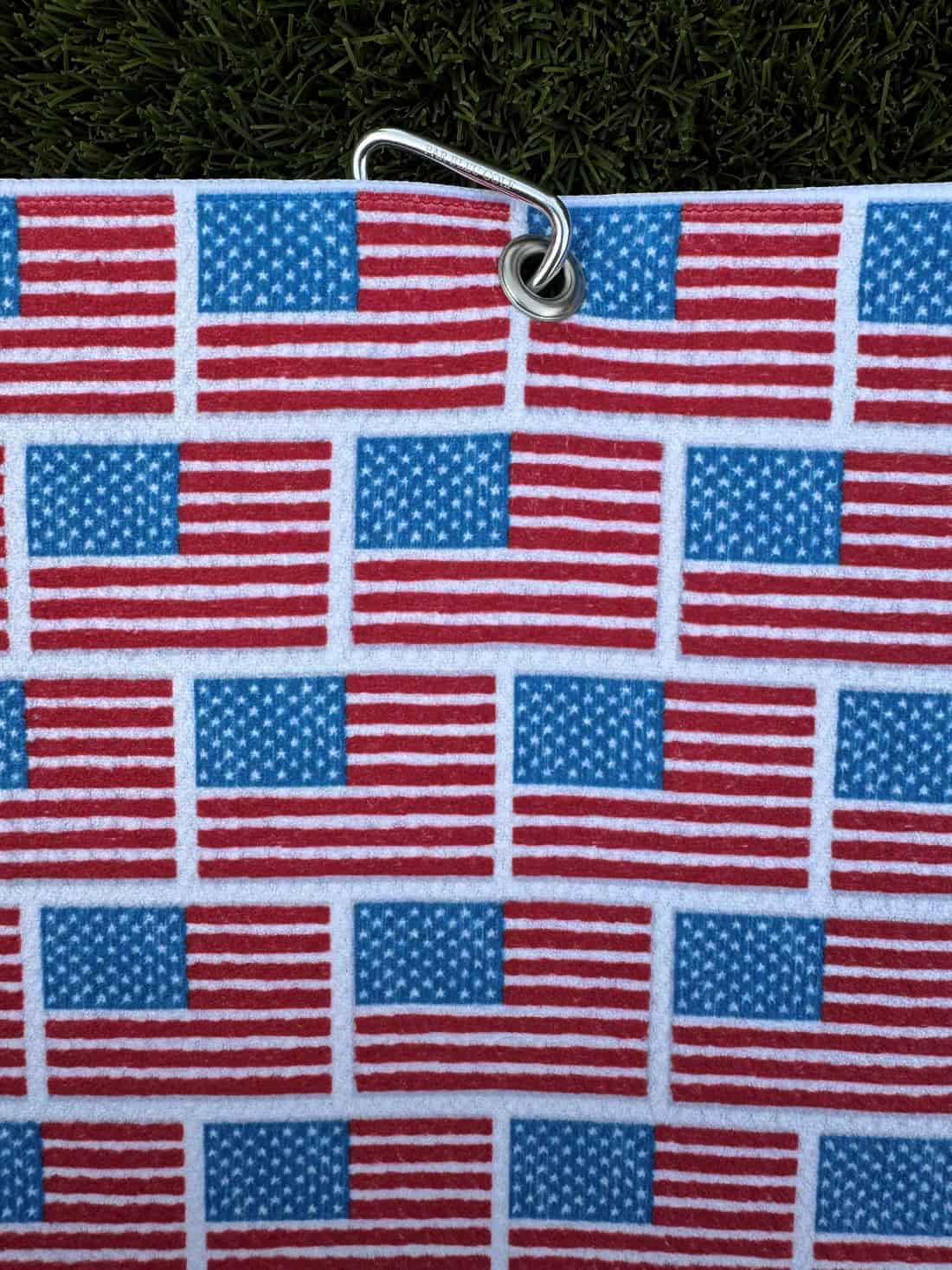 Top corner of the patriotic golf towel with grommet hole and included hook for easy bag attachment.