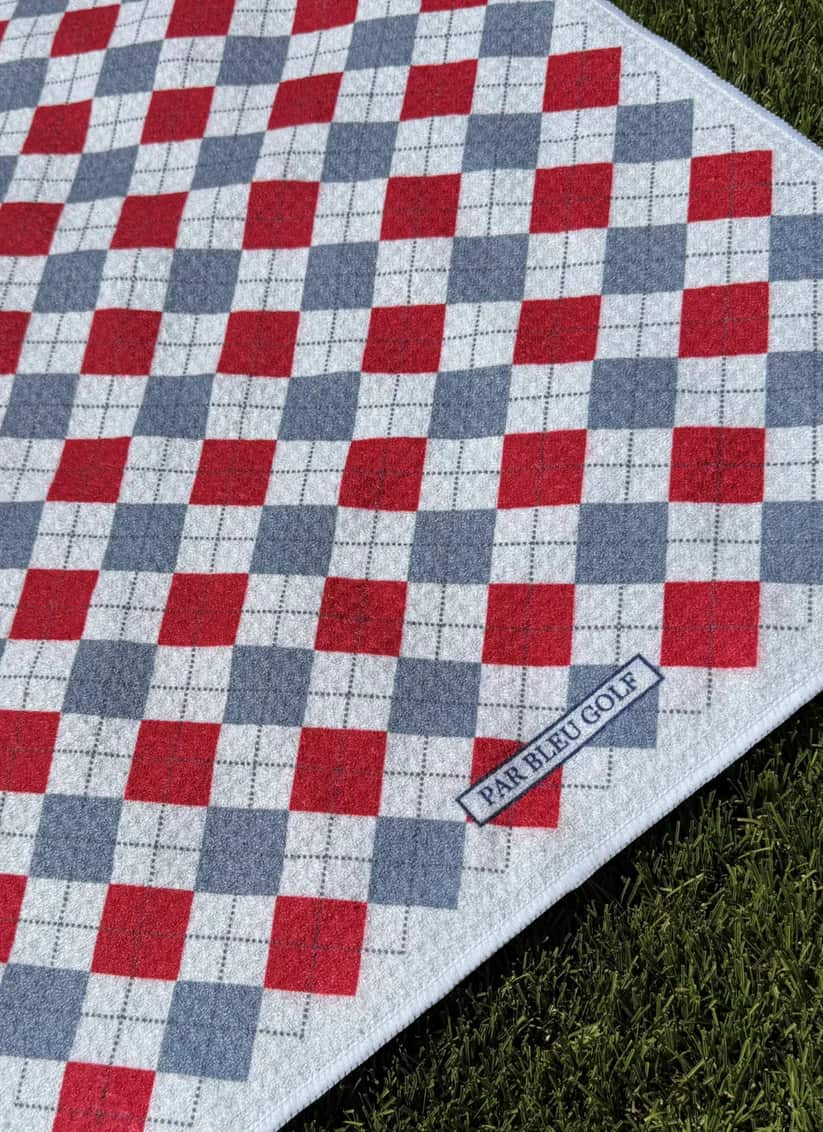Close-up of The Argyle Chipper: Cardinal & Grey towel with Par Bleu logo and bold plaid pattern