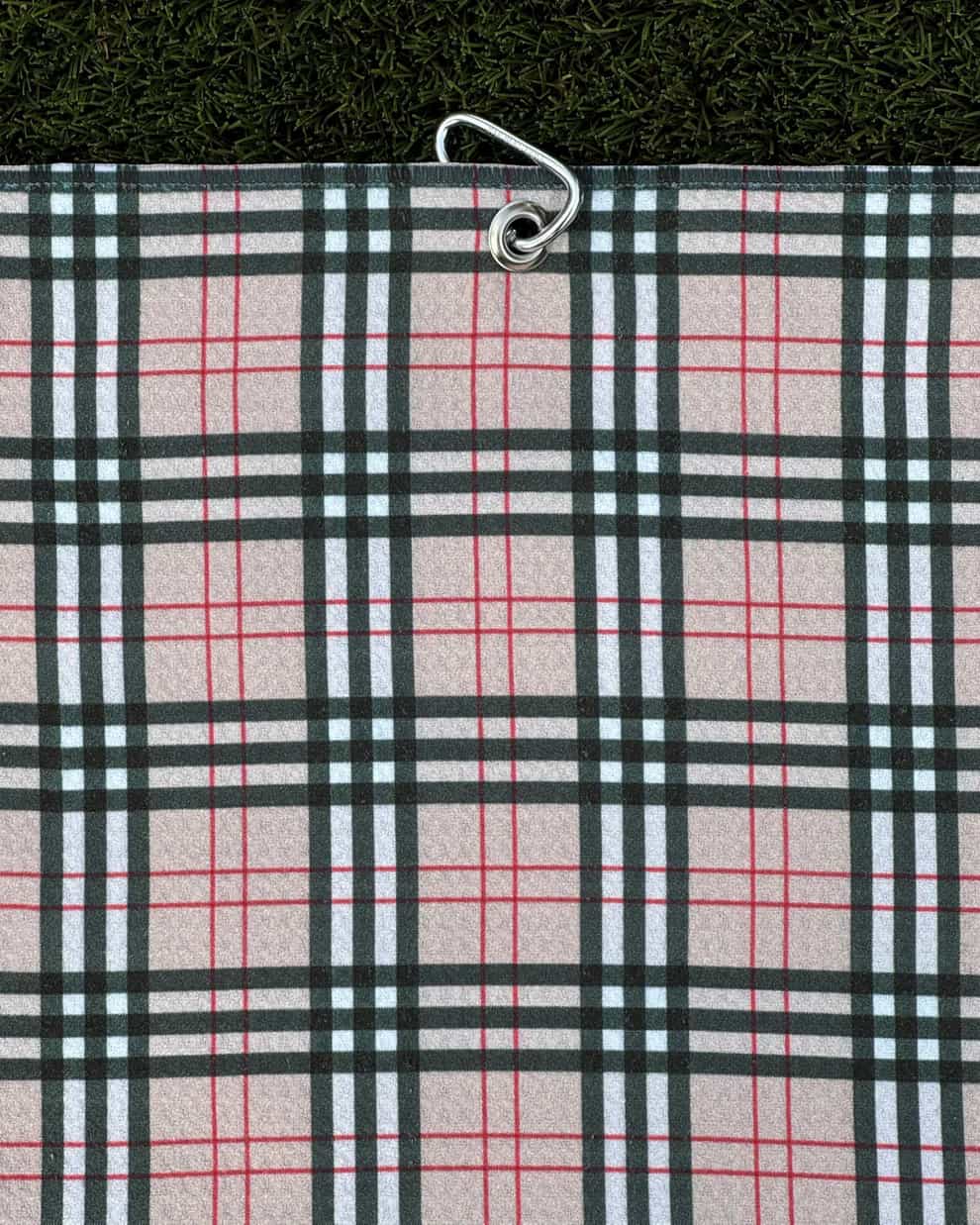 Burr Plaid golf towel hanging vertically with attached carabiner clip