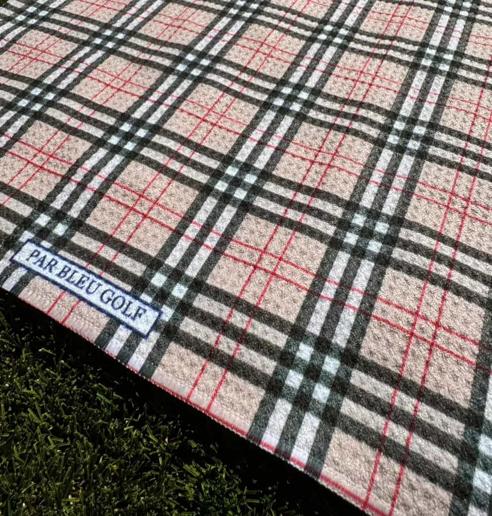 Close-up of Burr Plaid golf towel pattern with visible Par Bleu logo tag