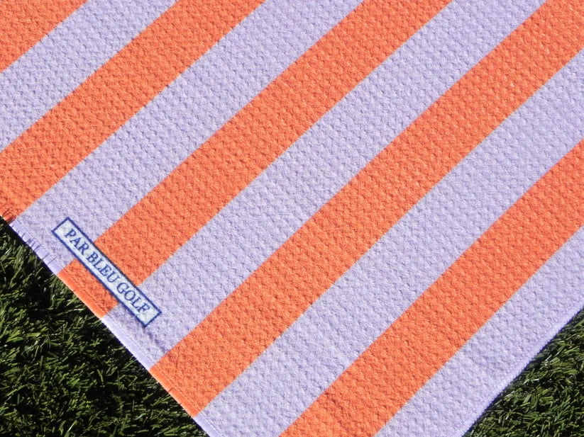 Close-up of The Cabana Stripe: Pink & Orange towel showing Par Bleu Golf logo and bold vertical stripes