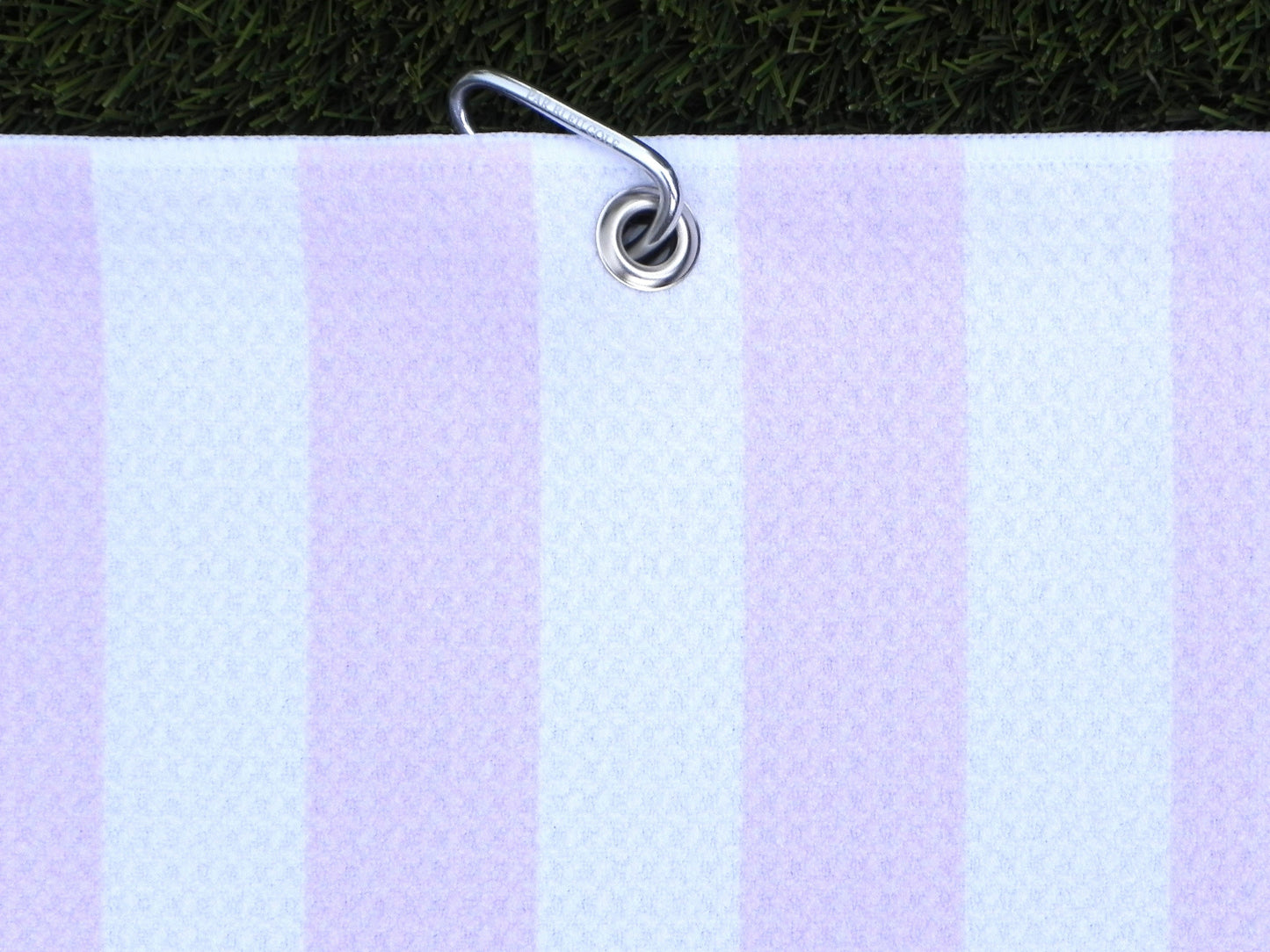 Women’s pink striped microfiber golf towel hanging with silver carabiner, perfect for golf bags