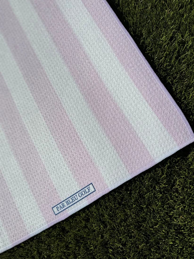 Close-up of The Cabana Stripe: Pink & White towel showing Par Bleu Golf logo and subtle pastel stripes