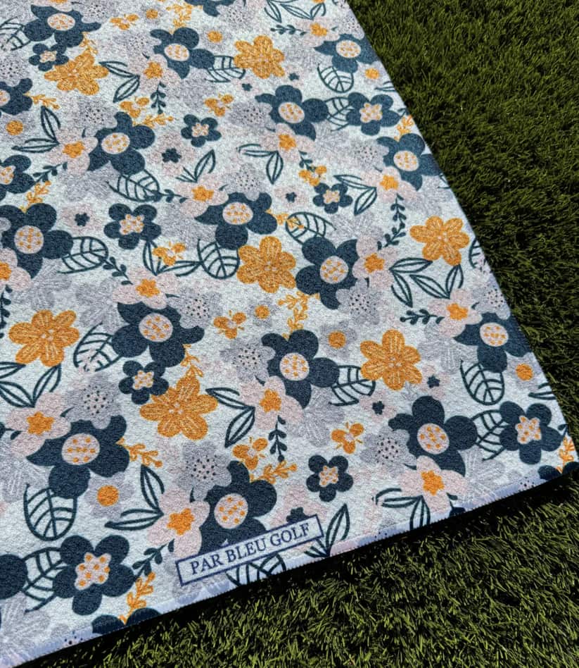 Close-up of Par Bleu Golf logo on The Floral in Greys microfiber towel with modern floral pattern for women