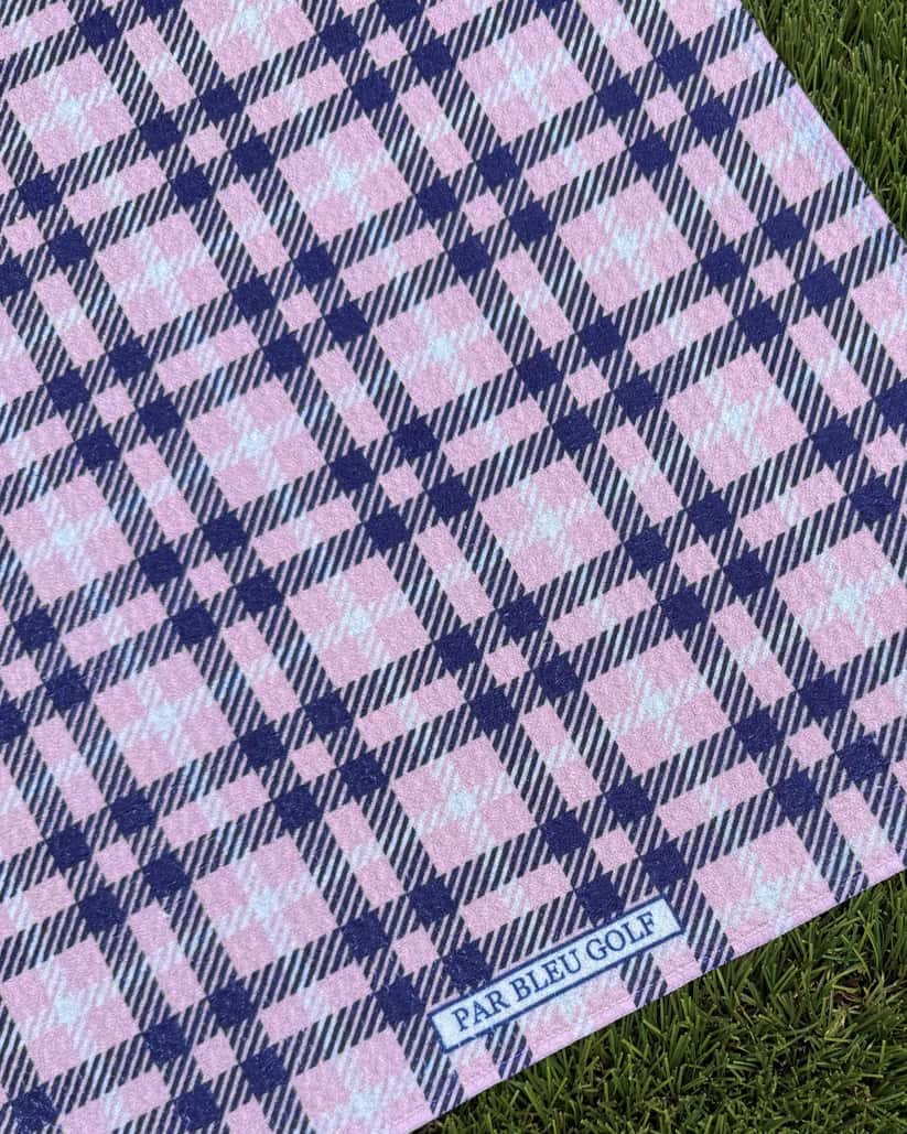 Close-up of The Pink Plaid microfiber golf towel showing Par Bleu logo and pink tartan pattern