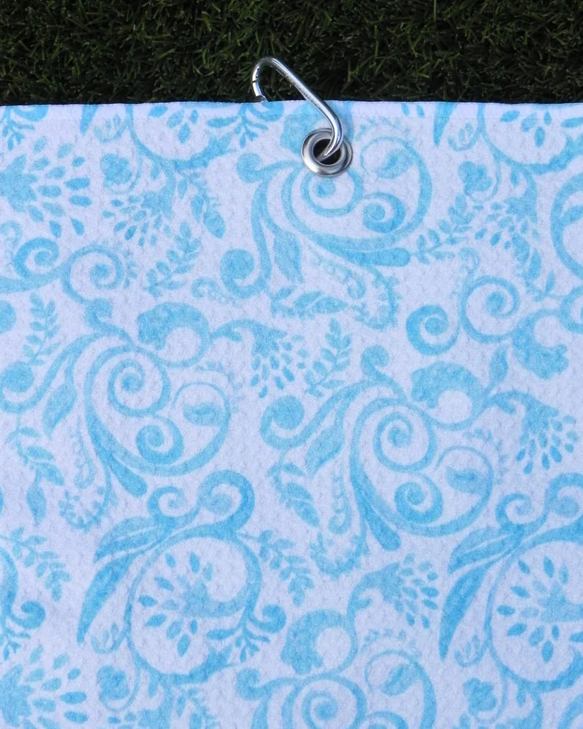 Golf towel with teal damask-inspired print, featuring sturdy metal carabiner for easy golf bag attachment