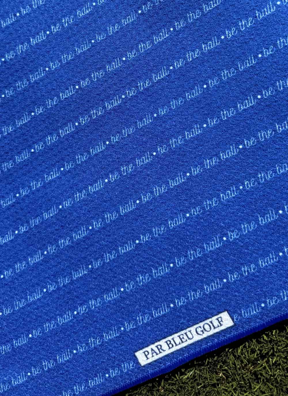Close-up of Be The Ball golf towel – durable stitching and bold print