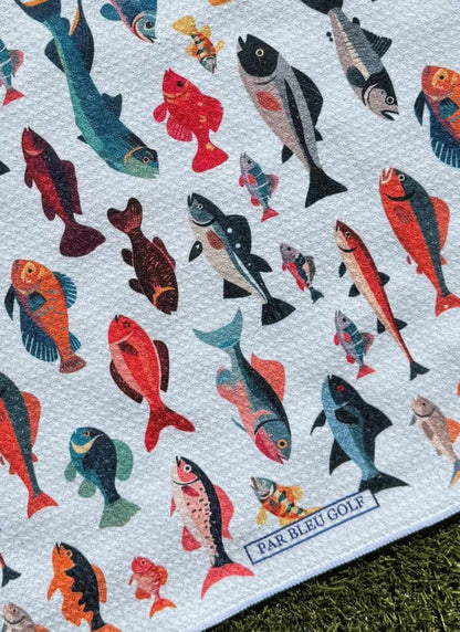 Close-up of Colorful Fishies patterned microfiber golf towel with multi-colored fish and Par Bleu logo