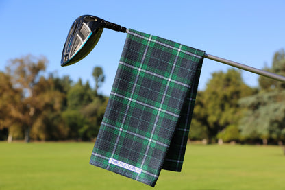 Emerald green and navy plaid golf towel hanging on a club, classic microfiber golf accessory