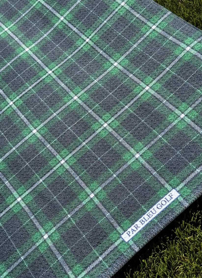 Close-up of emerald and navy plaid microfiber golf towel with Par Bleu Golf logo