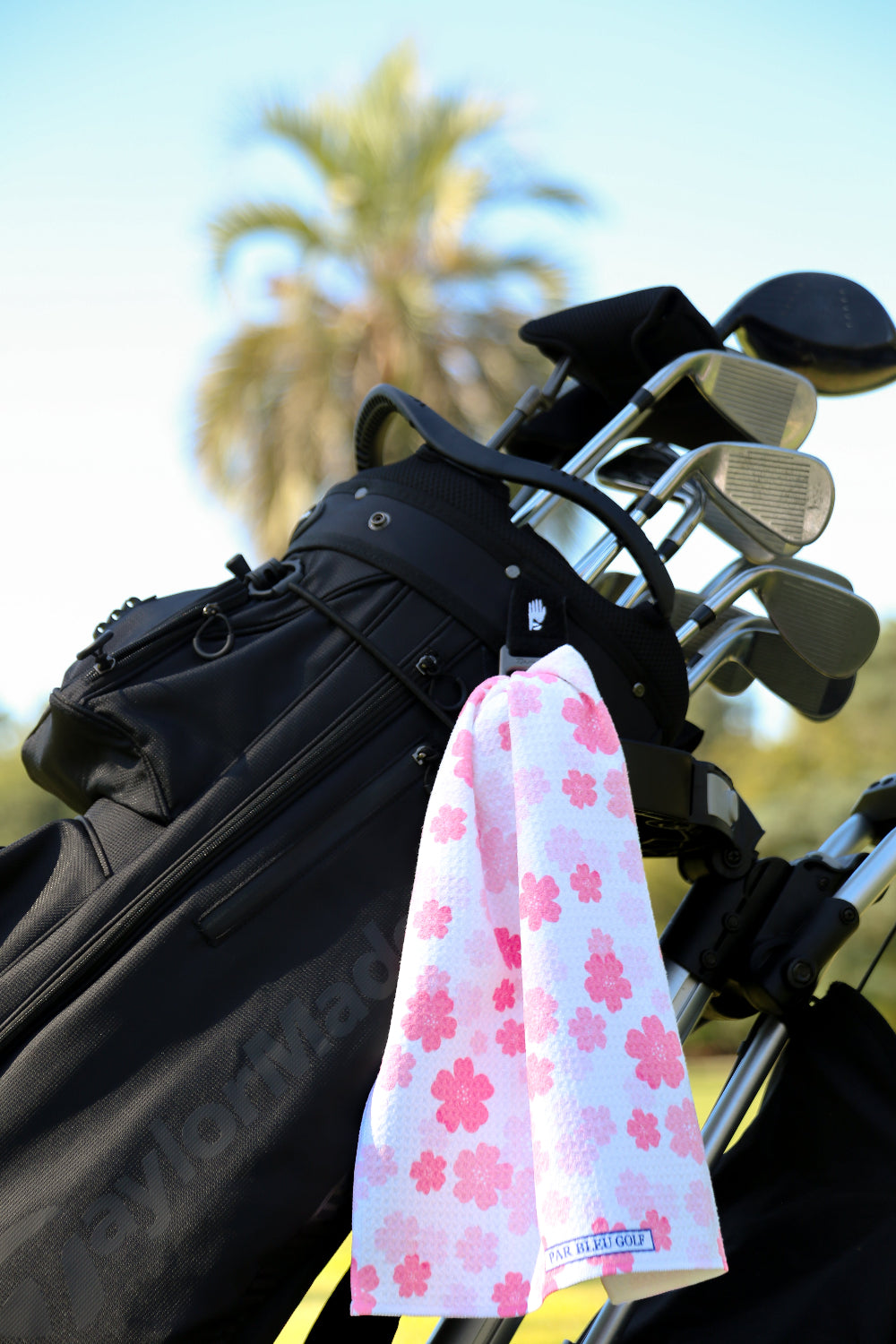 Feminine floral golf towel clipped to black golf bag, great gift idea for women who golf in style