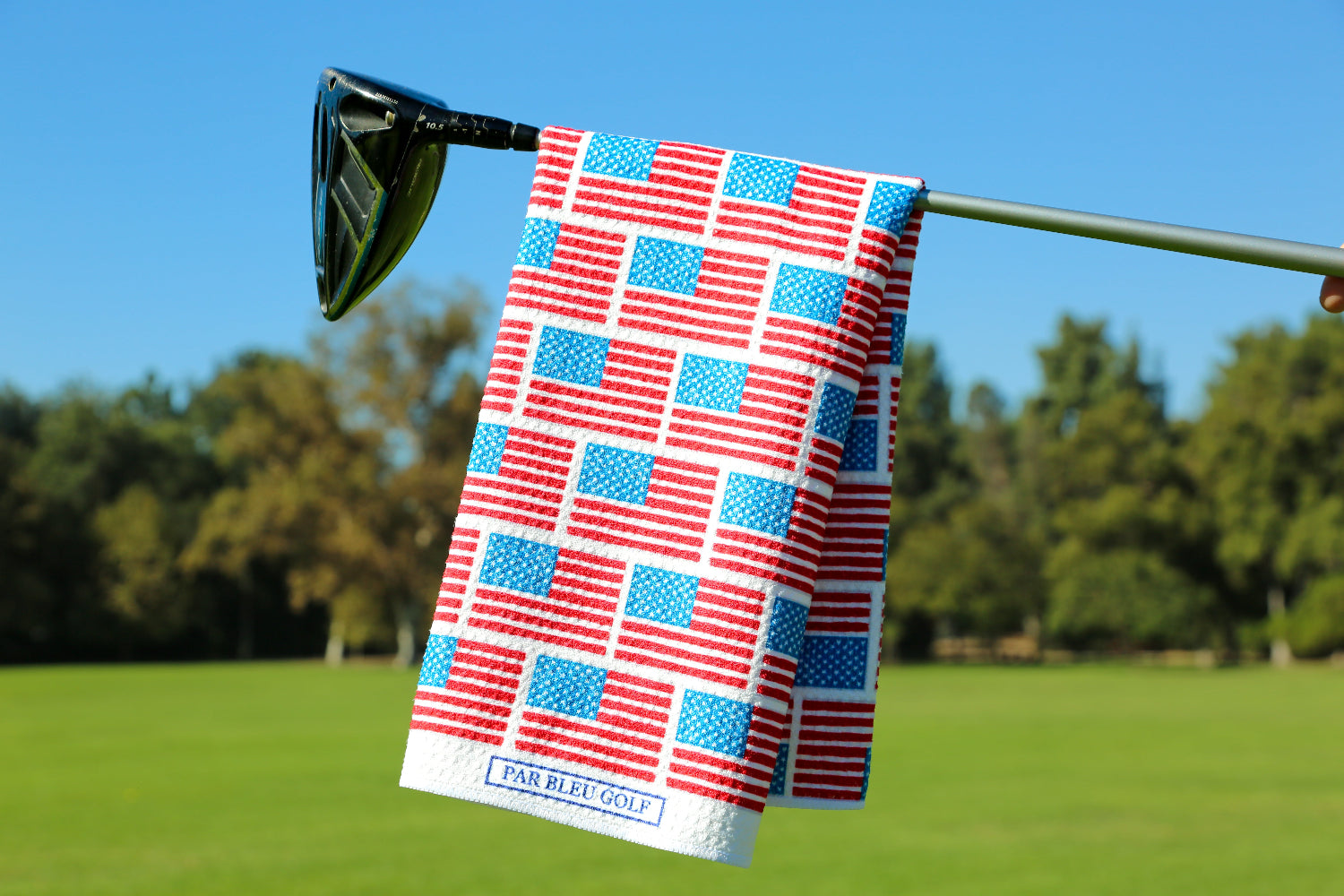 American flag golf towel draped over a club on the green, perfect for showing pride and style on the course.
