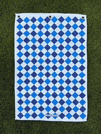 Blue & navy plaid golf towel laid flat on grass, made with soft and durable microfiber