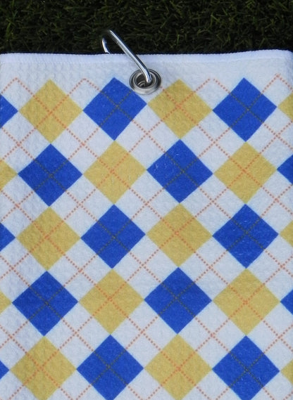Blue and yellow golf towel with classic argyle design hanging from durable carabiner clip