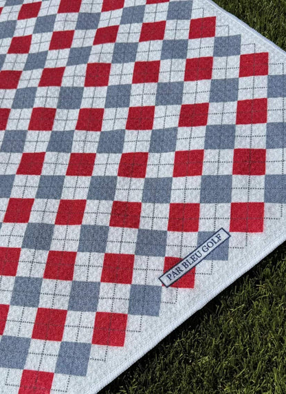 Close-up of The Argyle Chipper: Cardinal & Grey towel with Par Bleu logo and bold plaid pattern