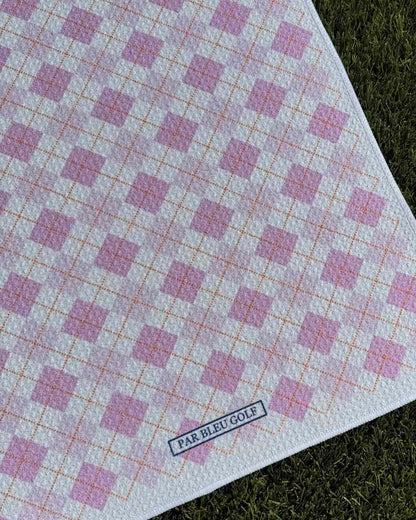 Close-up of The Argyle Chipper: Pink microfiber golf towel with Par Bleu logo and diamond pattern