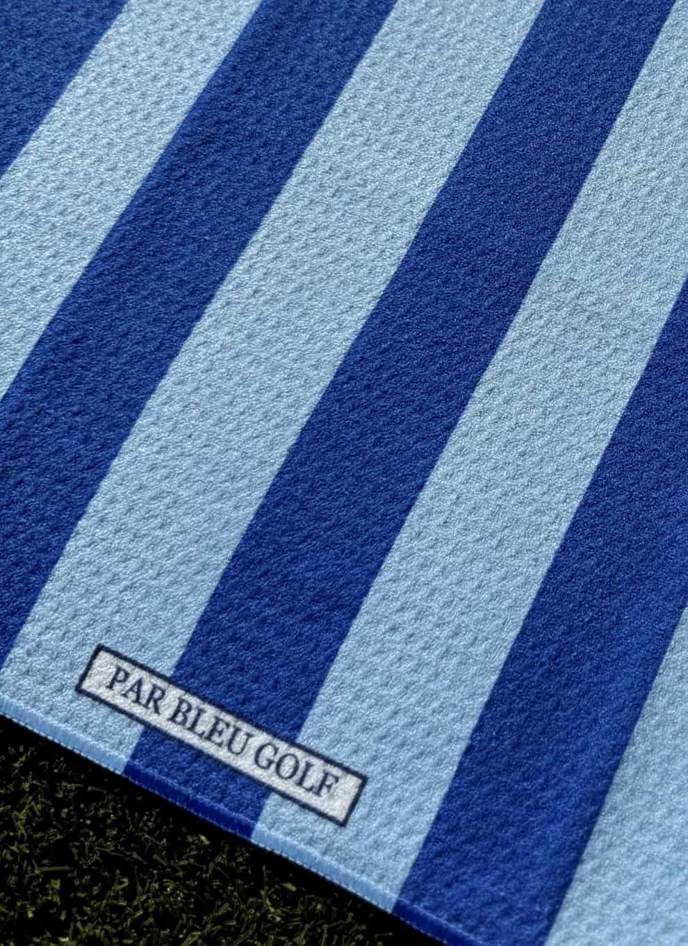 Close-up of The Cabana Stripe: Blue & Bleu towel showing Par Bleu logo tag