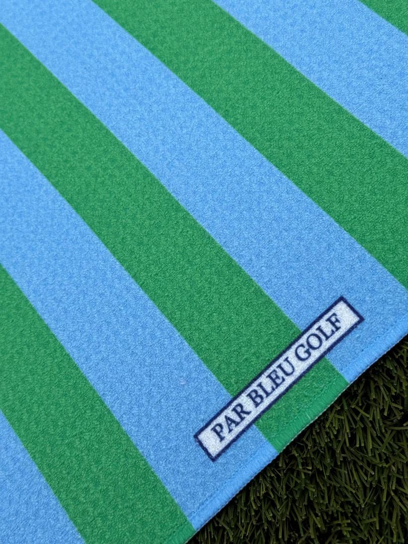 Close-up of The Cabana Stripe: Blue & Green towel with Par Bleu Golf logo and microfiber texture