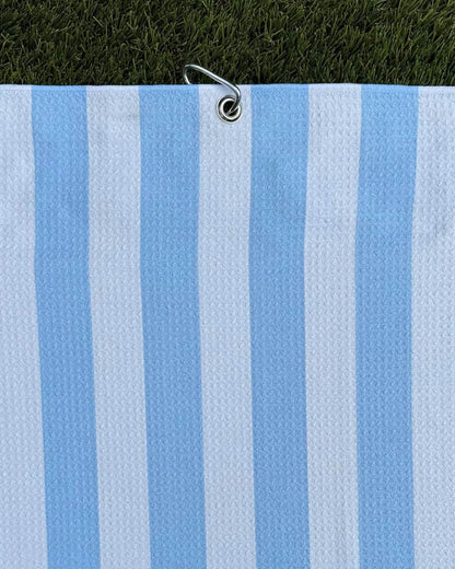 Cabana Stripe golf towel hanging vertically with carabiner and light blue and white stripes