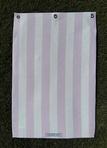 Soft pink and white striped microfiber towel laid flat on green grass, lightweight golf towel for her