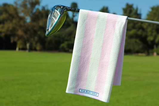 Pink and white striped golf towel hanging on a club, stylish microfiber accessory for women golfers