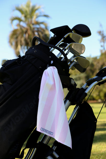 Light pink and white striped golf towel clipped to golf bag, great gift for stylish women golfers