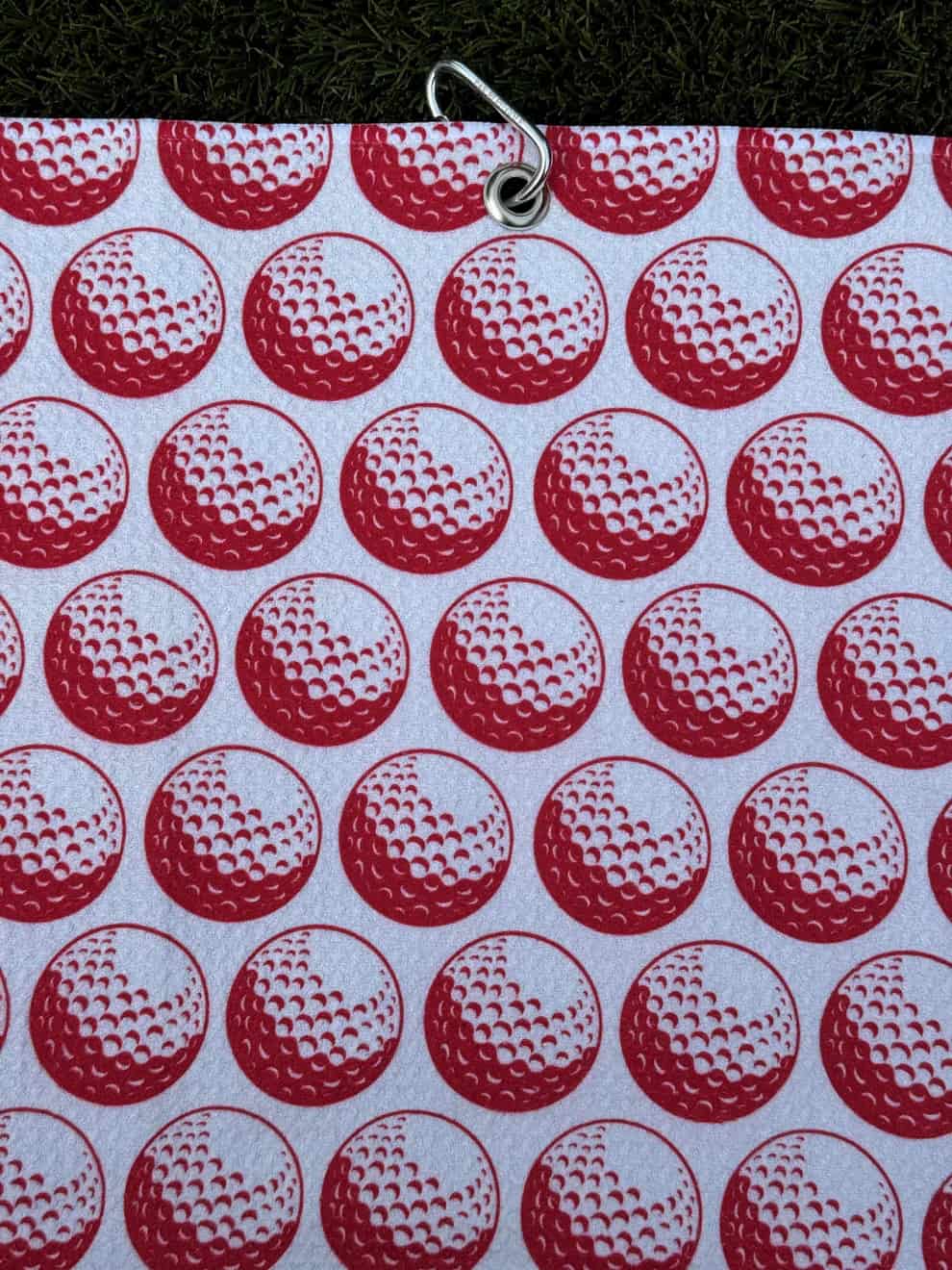 Par Bleu The Golf Ball: Red golf towel with close-up golf ball print and Carabiner