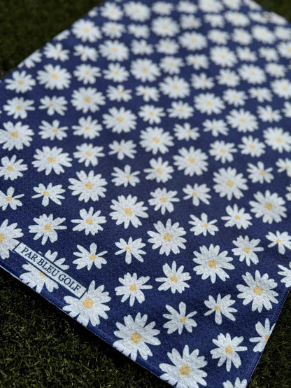 Close-up of The Navy Daisy women’s microfiber golf towel with Par Bleu logo and floral print