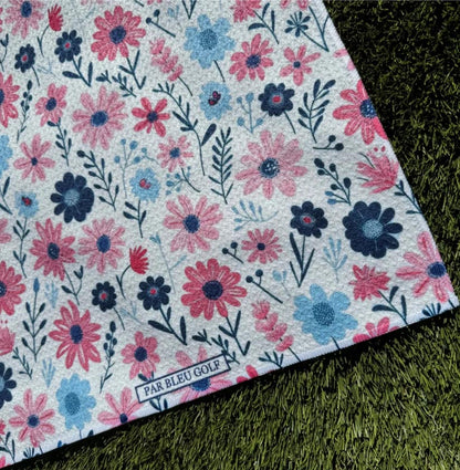 Close-up of The Pink & Navy Floral microfiber towel with Par Bleu logo and dainty flower design for women golfers