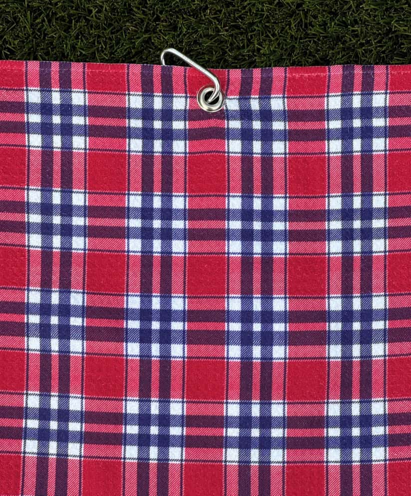 Classic red plaid golf towel hanging from silver carabiner, designed for easy golf bag attachment