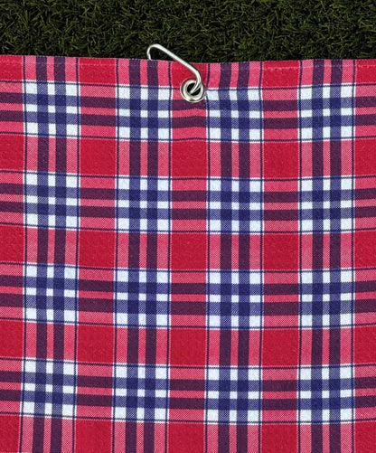 Classic red plaid golf towel hanging from silver carabiner, designed for easy golf bag attachment