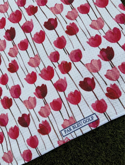 Close-up of Par Bleu Red Tulips microfiber women’s golf towel with elegant red and pink floral print