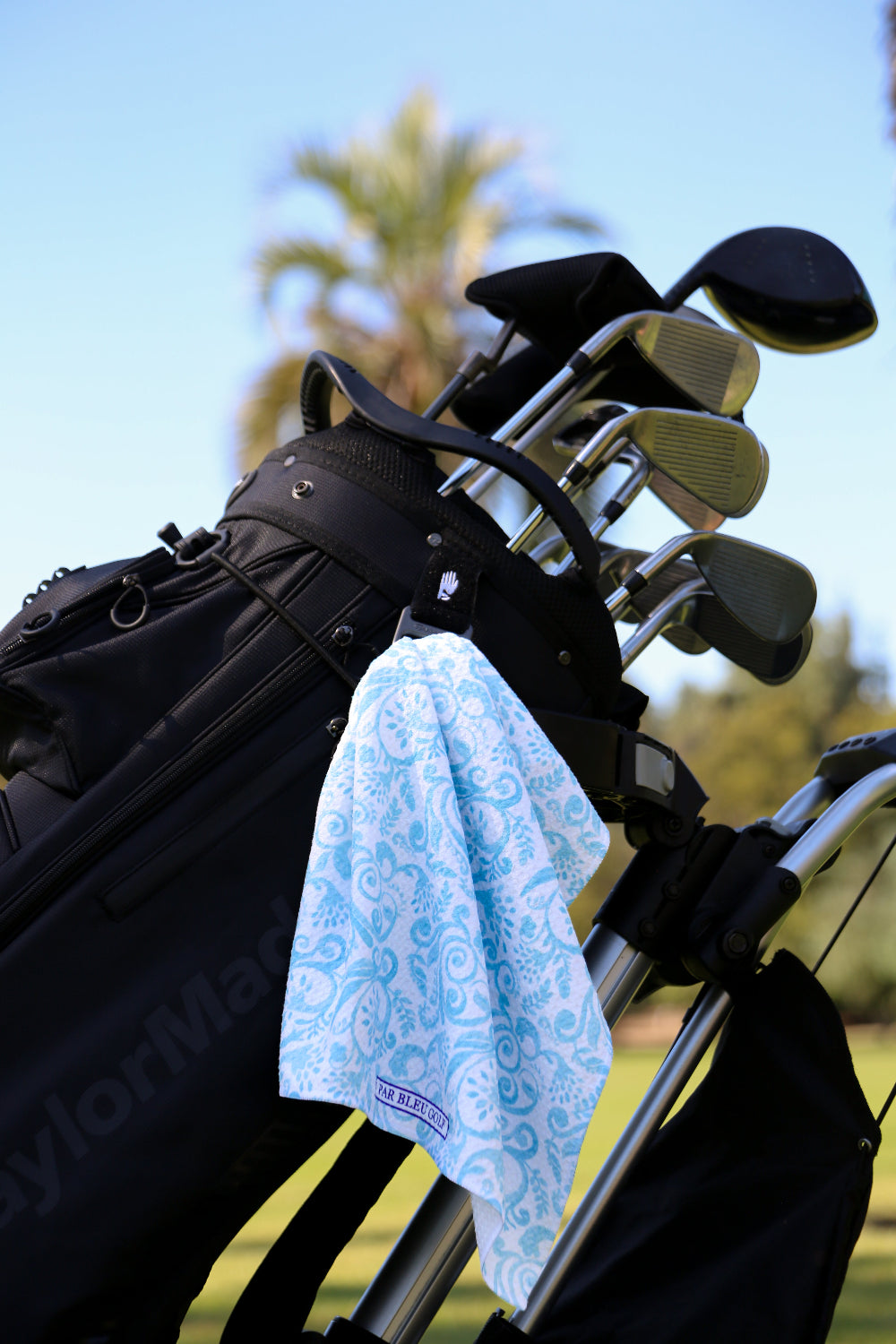 Feminine teal Toile towel clipped to golf bag, soft and absorbent microfiber for active play